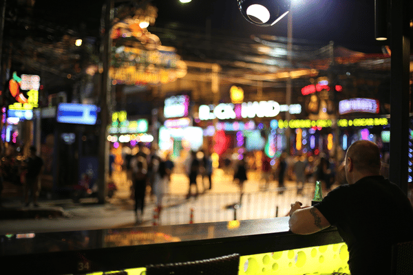 man sitting at a night bar on bangla road