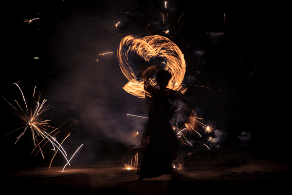 man performing a fire dance at the full moon party in phuket