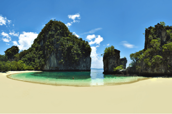 the sandy white beach located in ko hong island looking out to the limestone cliffs