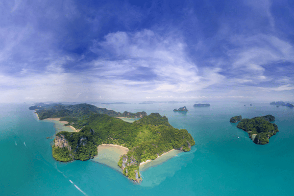 Drone footage of Koh Yao Noi with the ocean surrounding the idyllic lush green island