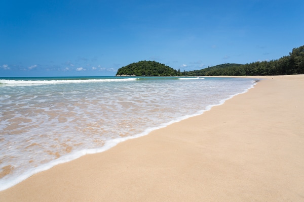 the wide spacious sandy beach along layan beach with the blue skies glistening