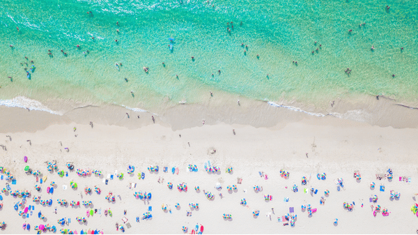 an aerial view of bangla road with people soaking in the sun on the beach