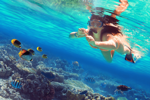 young woman snorkeling in karon beach
