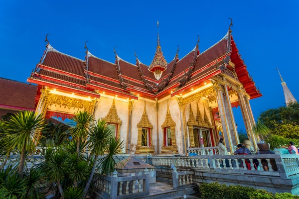 a nighttime photo taken of the wat chalong temple from the side