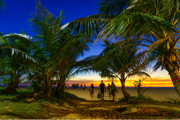 karon beach at sunset with tourists taking in the scenic view