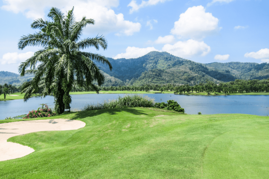 View over mountains and the surrounding water from the green at Loch Palm golf club in Phuket