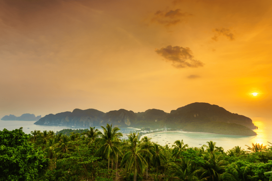 a glorious view of the Phi Phi islands with the sun setting over the horizon
