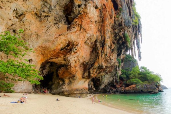 Visitors relaxing at a cave beach in Thailand on Krabi Island