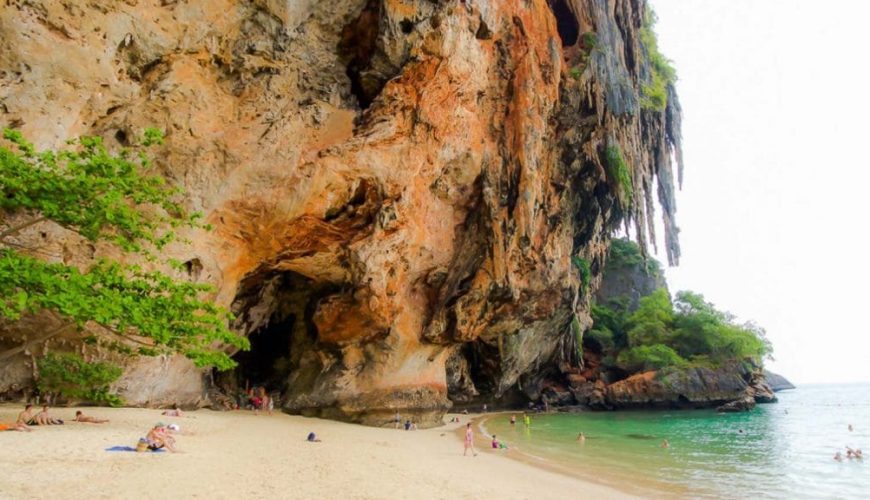 Visitors relaxing at a cave beach in Thailand on Krabi Island