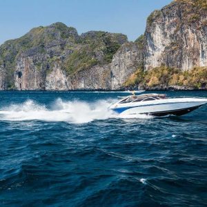Speedboat in Phi Phi Islands with limestone cliffs in the background