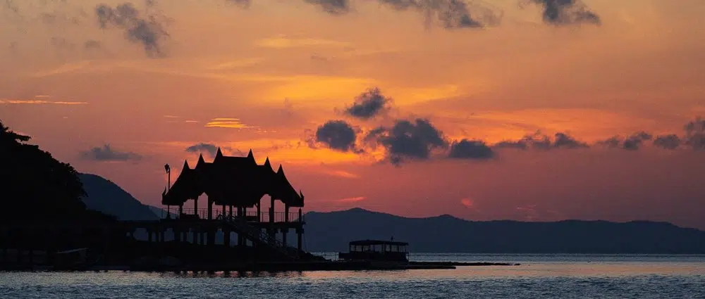 an image of Phang Nga Bay at sunset as our tour boat sails towards the region.