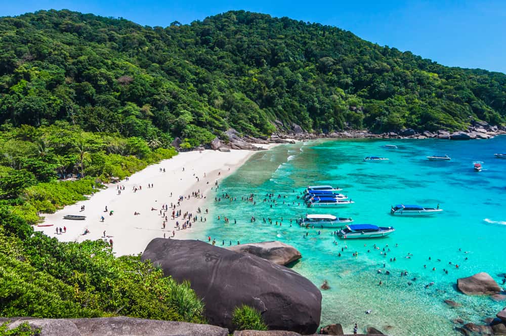 the Similan Islands at noon as seen from the lookout point with many boats anchored to allow swimmers an afternoon of fun