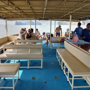 A Simba Sea Trips boat with benches and tables for passengers to sit on