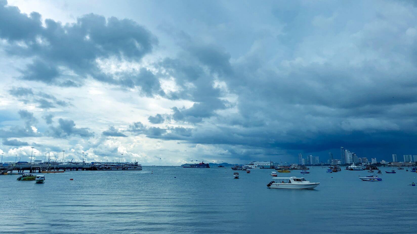A beautiful shot over the Andaman Sea with boats in the foreground and cloudy skies in the background