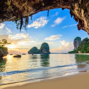 A photo through the cave at Phra Nang Cave Beach looking out into the sea to the limekarst cliffs in the distance