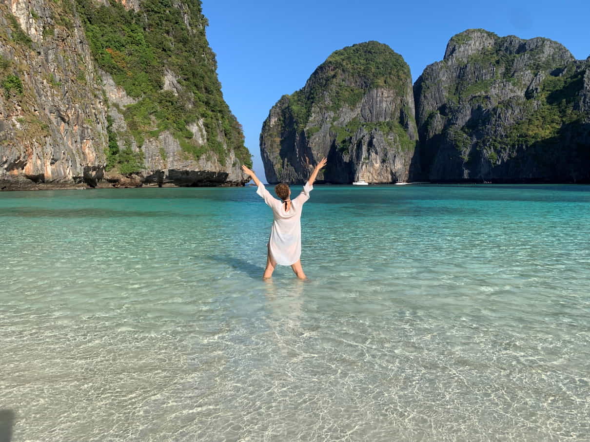 Woman standing in the calm waters of Maya Bay