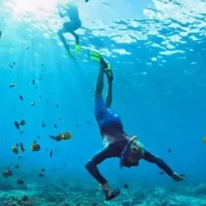 A man snorkeling in Thailand waters, exploring the underwater world with a snorkel and mask.