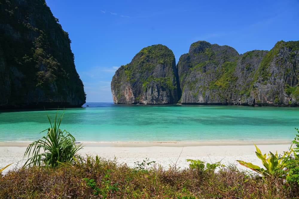 Stunning Maya Bay in Thailand with crystal clear waters and lush green cliffs