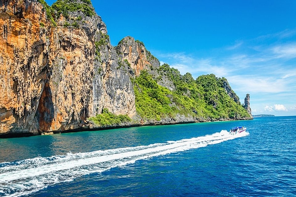 A Simba Sea Trips speedboat on calm early-morning water in the Andaman