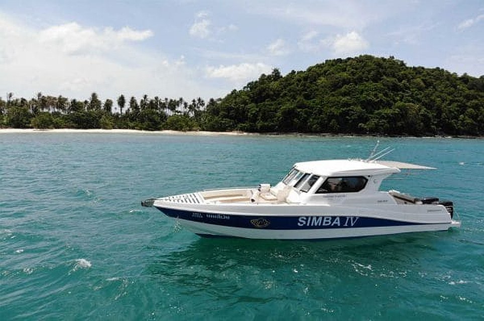 simba sea trips charter boat anchored in the middle of calm Phuket waters